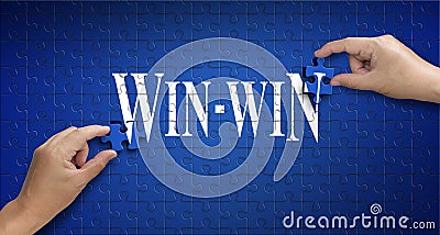 Win win word on Jigsaw puzzle. Man hand holding a blue puzzle to Stock Photo